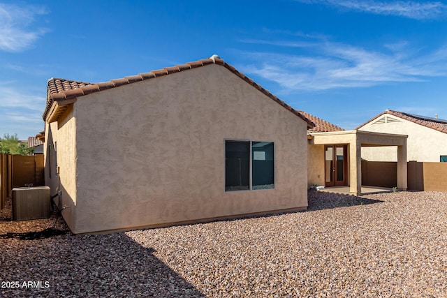 6331 W Desert Blossom Way, Florence, AZ 85132 - back of property with central air condition unit, a patio, and stucco siding