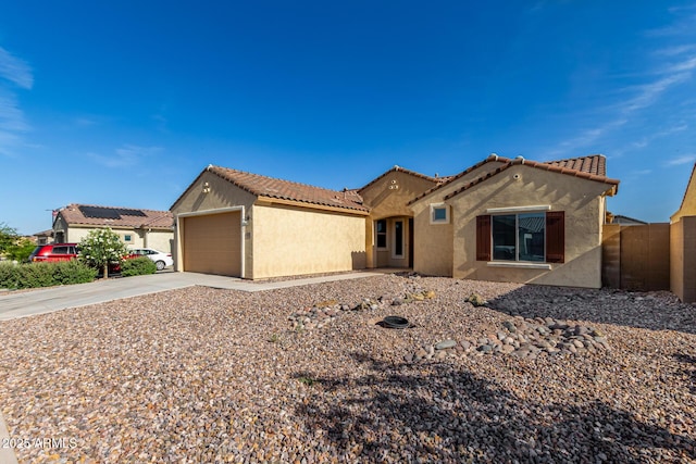 6331 W Desert Blossom Way, Florence, AZ 85132 - mediterranean / spanish-style home featuring stucco siding, concrete driveway, a tile roof, and a garage