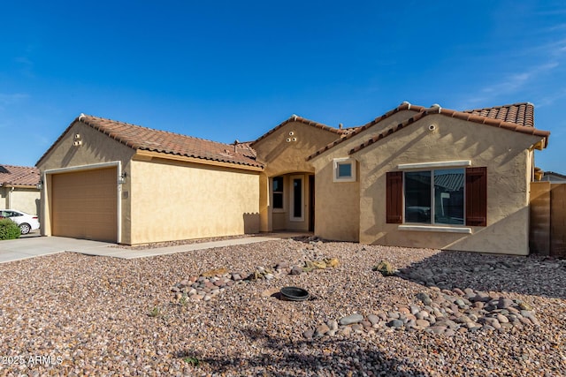 6331 W Desert Blossom Way, Florence, AZ 85132 - mediterranean / spanish house with stucco siding, driveway, a tiled roof, and a garage