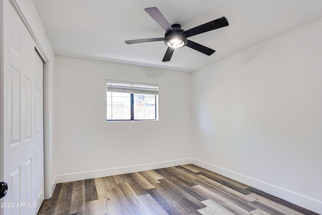 unfurnished bedroom featuring a closet, baseboards, and wood finished floors