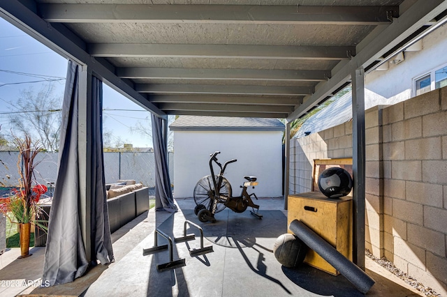 exercise room featuring concrete block wall