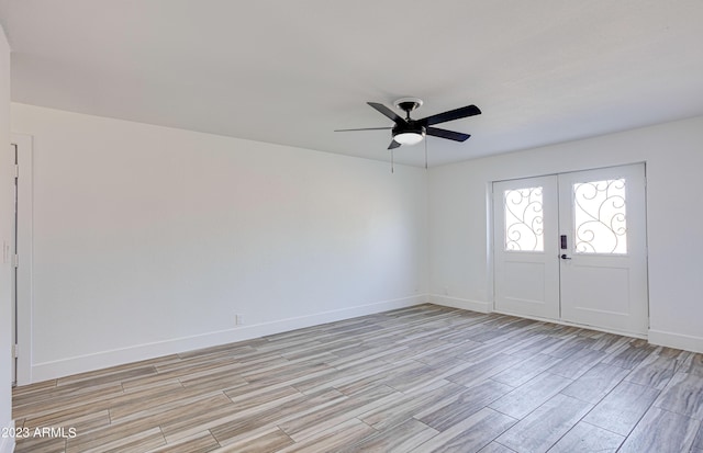 entrance foyer featuring wood tiled floor, baseboards, and a ceiling fan