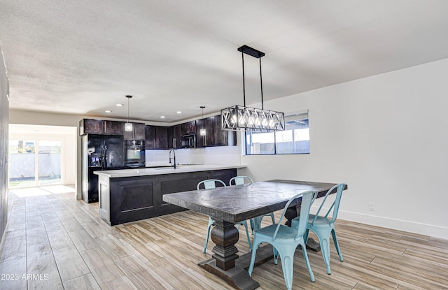 dining room with recessed lighting, light wood-type flooring, and baseboards