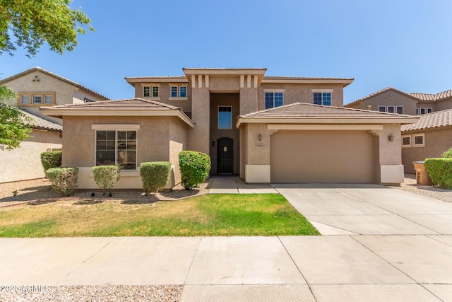 17419 W Elaine Dr, Goodyear, AZ 85338 - view of front of house featuring a garage, stucco siding, concrete driveway, a front lawn, and a tile roof
