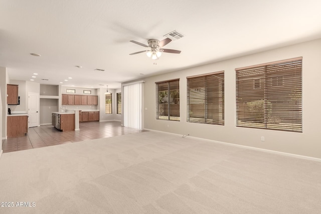 17419 W Elaine Dr, Goodyear, AZ 85338 - unfurnished living room featuring ceiling fan, light carpet, and light tile patterned flooring