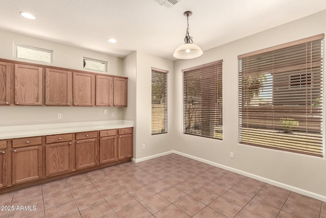 17419 W Elaine Dr, Goodyear, AZ 85338 - kitchen with pendant lighting, light countertops, brown cabinetry, light tile patterned flooring, and recessed lighting