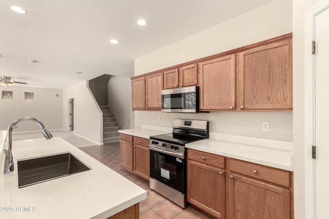 17419 W Elaine Dr, Goodyear, AZ 85338 - kitchen featuring appliances with stainless steel finishes, recessed lighting, light tile patterned floors, light countertops, and ceiling fan
