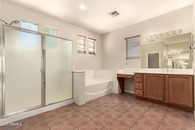17419 W Elaine Dr, Goodyear, AZ 85338 - full bath featuring vanity, a garden tub, a shower stall, and tile patterned flooring