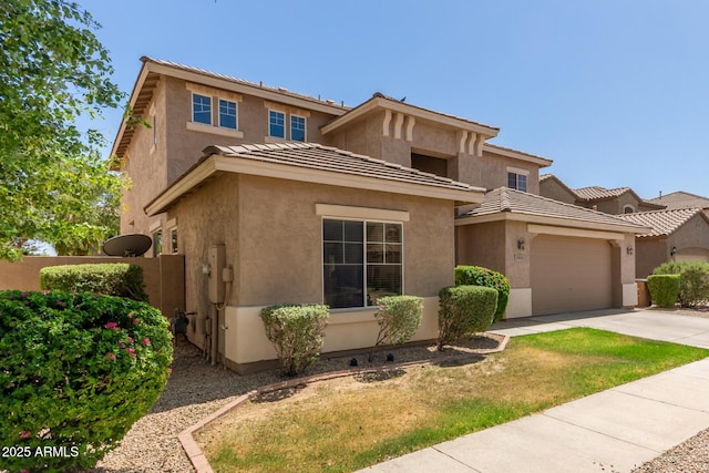 17419 W Elaine Dr, Goodyear, AZ 85338 - view of front of house featuring concrete driveway, a garage, stucco siding, and a tiled roof