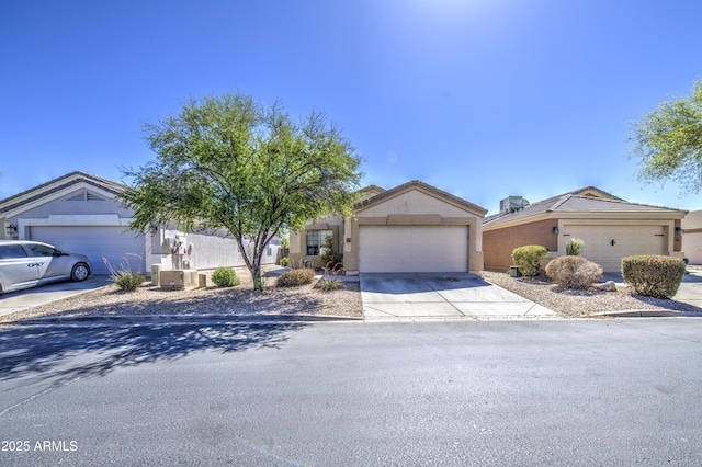 23993 N Desert Dr, Florence, AZ 85132 - view of front facade featuring concrete driveway, an attached garage, and stucco siding