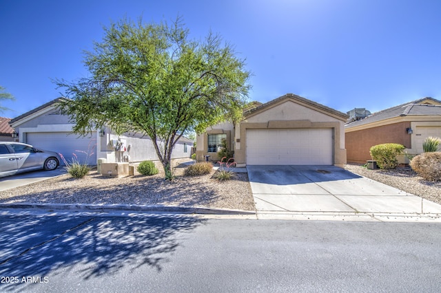 23993 N Desert Dr, Florence, AZ 85132 - view of property hidden behind natural elements featuring concrete driveway, a garage, and stucco siding
