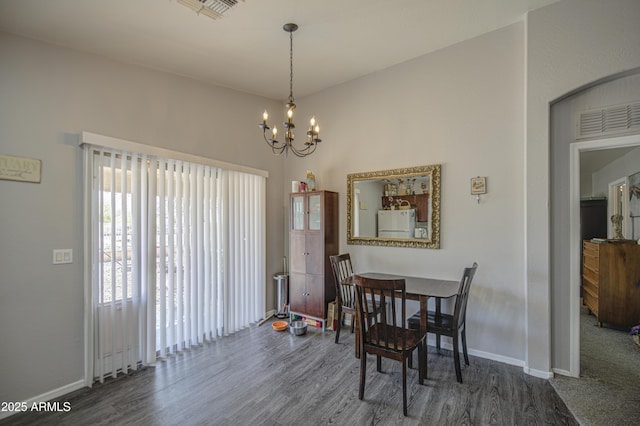 23993 N Desert Dr, Florence, AZ 85132 - dining area featuring wood finished floors, a chandelier, and baseboards