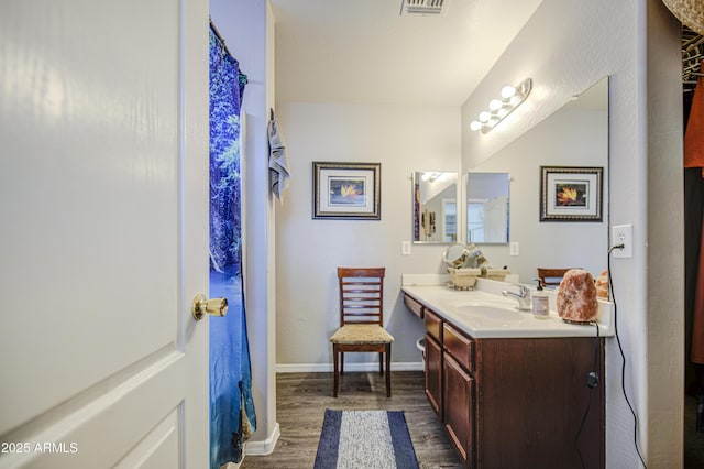 23993 N Desert Dr, Florence, AZ 85132 - full bathroom with wood finished floors, vanity, and baseboards