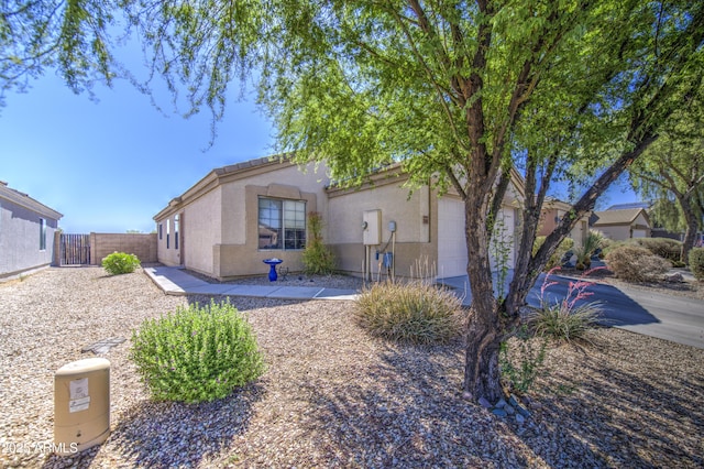 23993 N Desert Dr, Florence, AZ 85132 - view of front of house featuring an attached garage, stucco siding, and fence