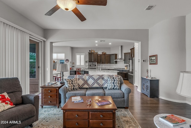 living room featuring sink, ceiling fan, and hardwood / wood-style flooring