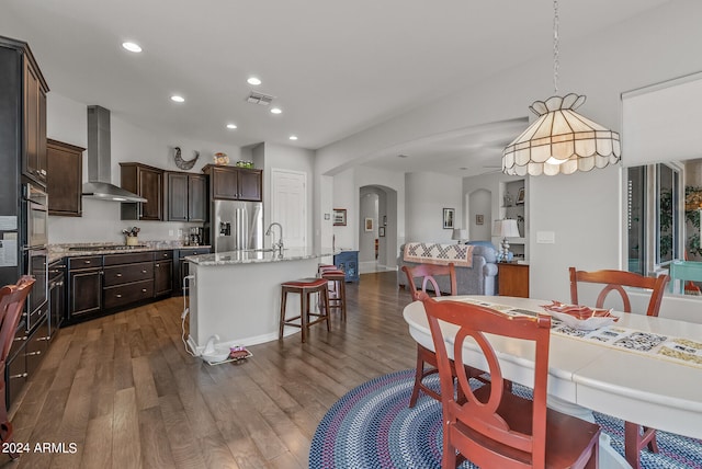 dining area featuring sink and dark wood-type flooring