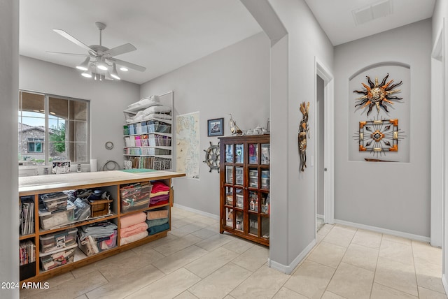 interior space featuring ceiling fan and light tile floors