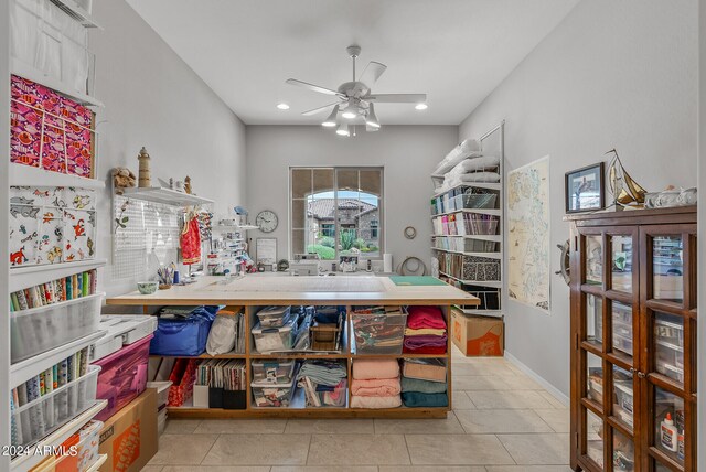 interior space with ceiling fan and light tile flooring