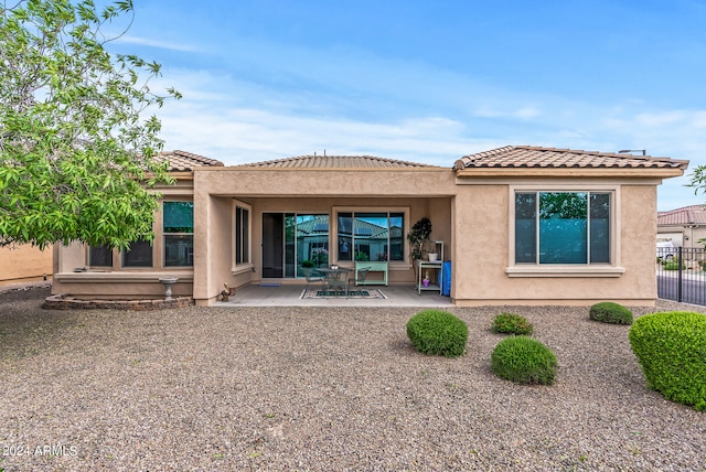 back of property featuring a patio area