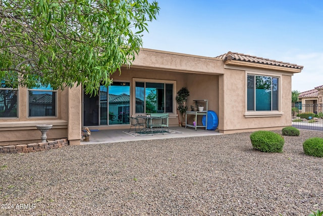 back of property featuring a patio area