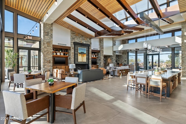 dining room featuring high vaulted ceiling and beam ceiling