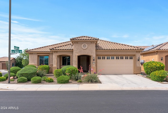 mediterranean / spanish-style home with a garage