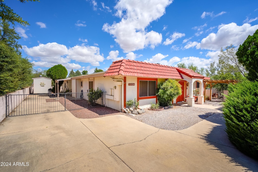 mediterranean / spanish-style home with a storage shed