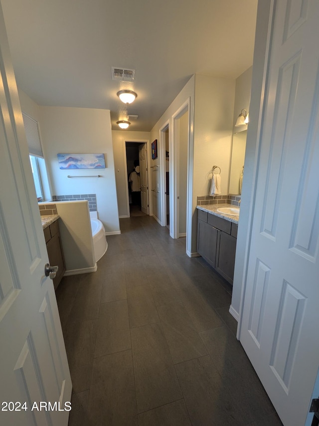 bathroom featuring tile patterned floors, vanity, and a bath