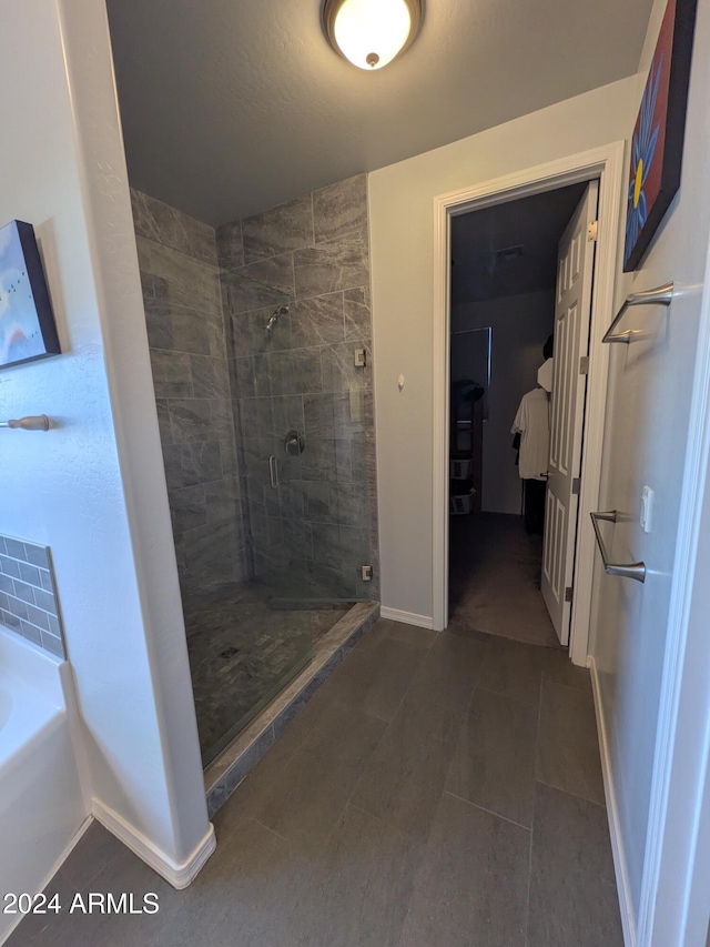 bathroom featuring shower with separate bathtub