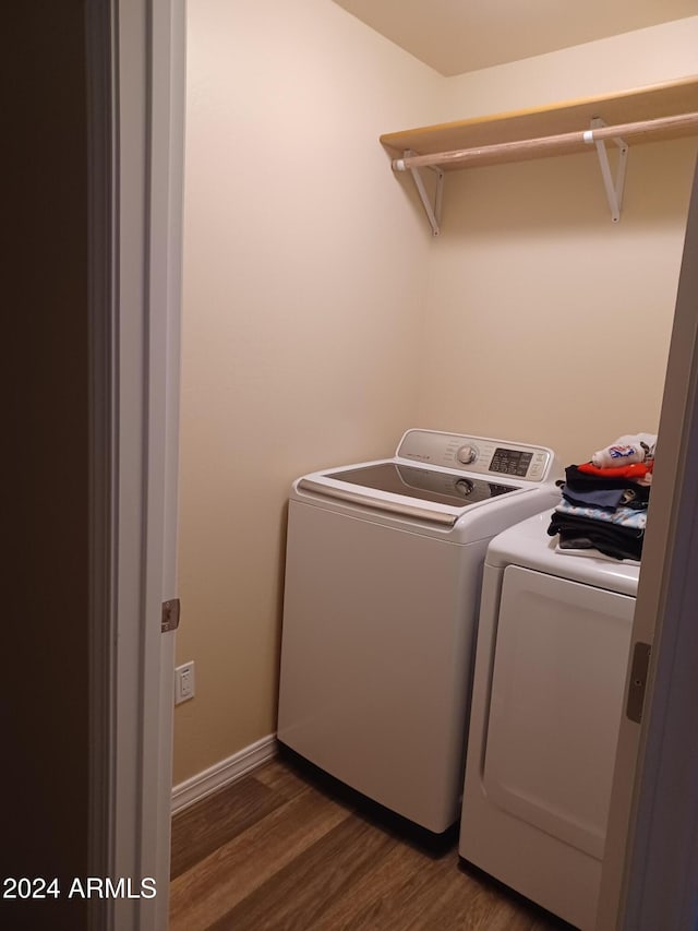 laundry area featuring dark hardwood / wood-style flooring and independent washer and dryer