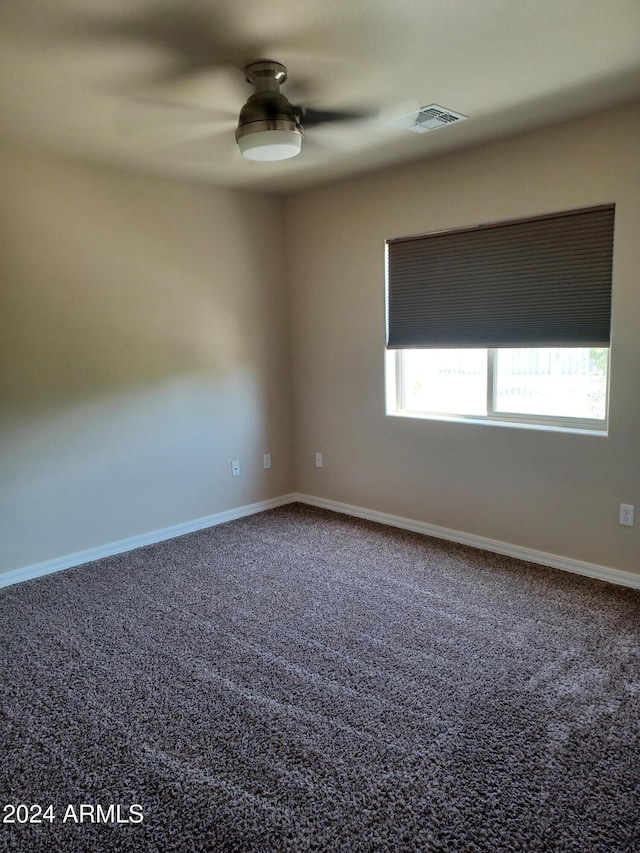 unfurnished room featuring ceiling fan and carpet floors