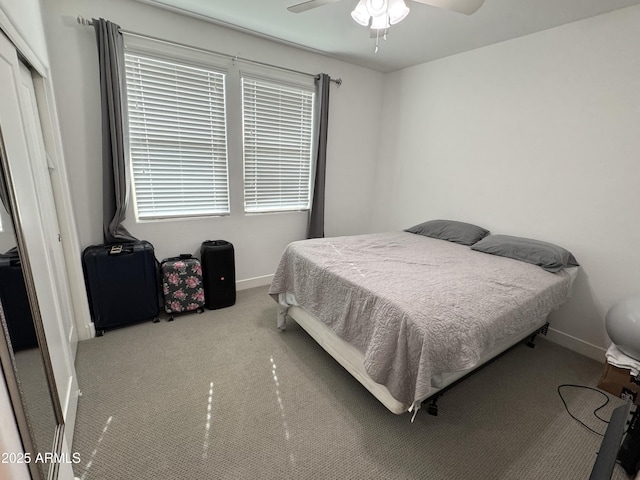 bedroom featuring carpet flooring, multiple windows, ceiling fan, and a closet