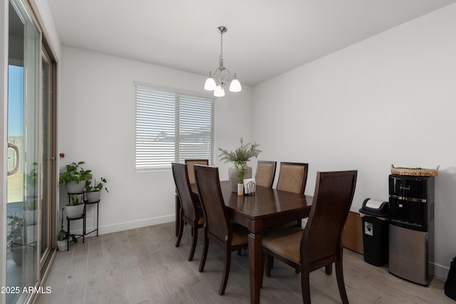 dining room featuring light hardwood / wood-style flooring and a chandelier