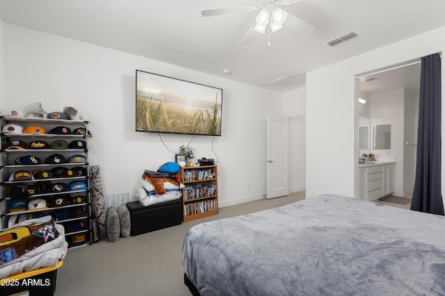 bedroom featuring ceiling fan, light carpet, and connected bathroom