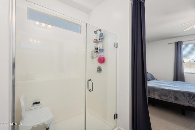 bathroom with an enclosed shower and ceiling fan