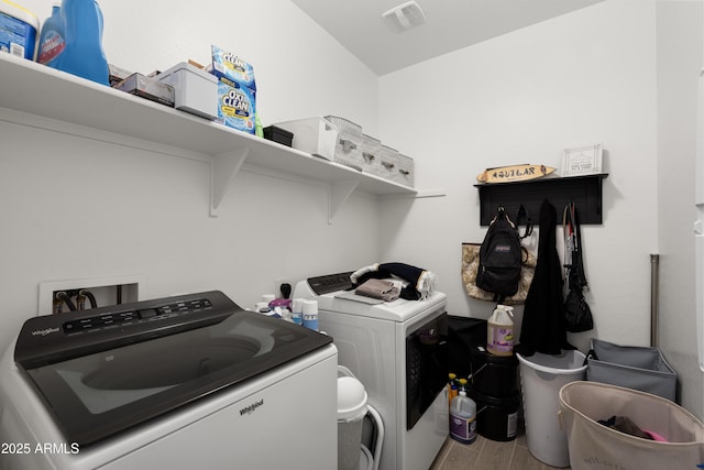 washroom featuring wood-type flooring and independent washer and dryer