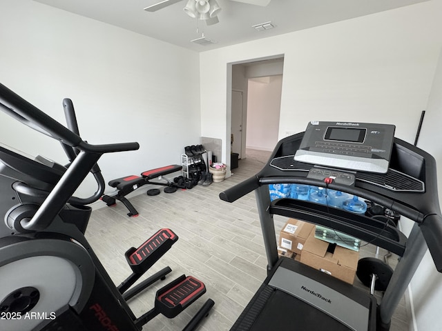 workout area featuring light hardwood / wood-style floors and ceiling fan