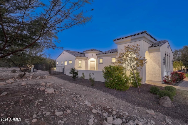 20594 W Pasadena Ave, Buckeye, AZ 85396 - view of side of property featuring a tiled roof, a gate, and stucco siding