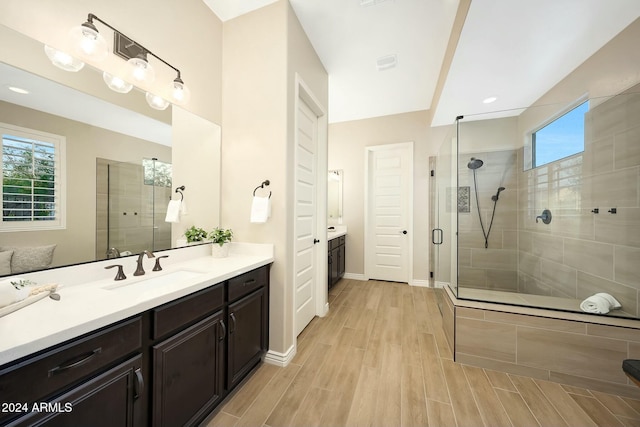20594 W Pasadena Ave, Buckeye, AZ 85396 - bathroom featuring vanity, a shower stall, wood finished floors, and baseboards