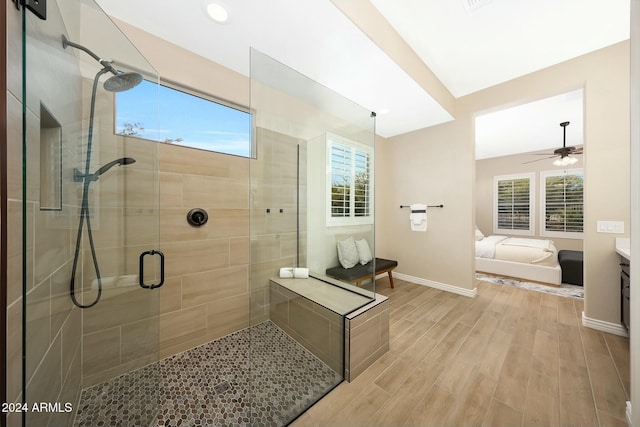 20594 W Pasadena Ave, Buckeye, AZ 85396 - ensuite bathroom featuring wood finished floors, a stall shower, healthy amount of natural light, and baseboards