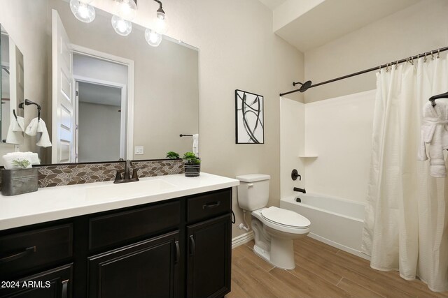 20594 W Pasadena Ave, Buckeye, AZ 85396 - full bathroom featuring toilet, vanity, wood finished floors, shower / bath combo with shower curtain, and baseboards