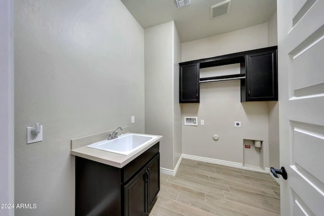 washroom featuring electric dryer hookup, cabinets, gas dryer hookup, sink, and hookup for a washing machine