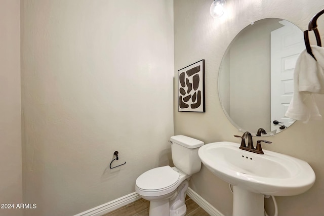 20594 W Pasadena Ave, Buckeye, AZ 85396 - half bath with toilet, baseboards, and wood finished floors