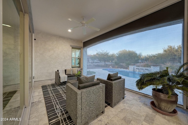 sunroom / solarium featuring ceiling fan