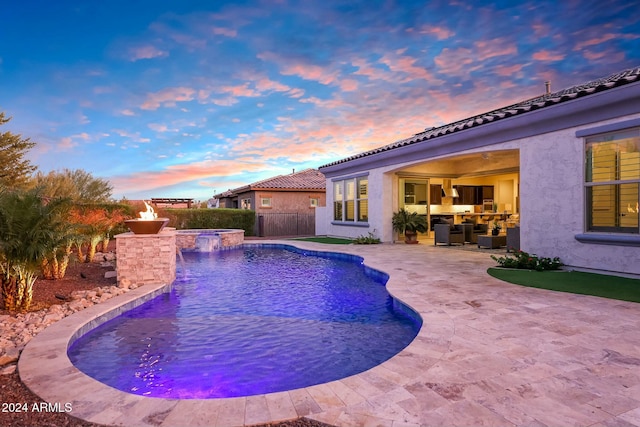 pool at dusk with a patio area