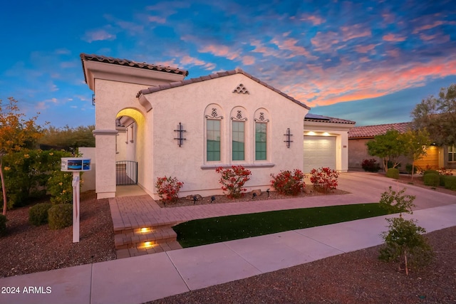 20594 W Pasadena Ave, Buckeye, AZ 85396 - mediterranean / spanish house with a garage, stucco siding, driveway, and a gate