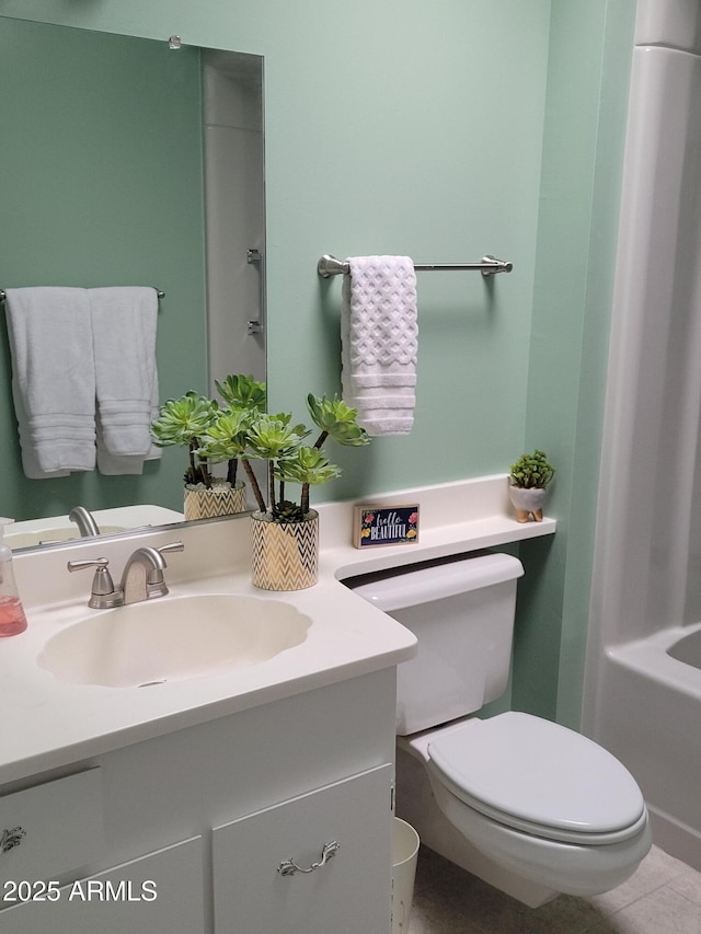 bathroom with vanity, a tub to relax in, and toilet