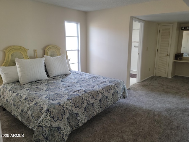 carpeted bedroom with ensuite bath