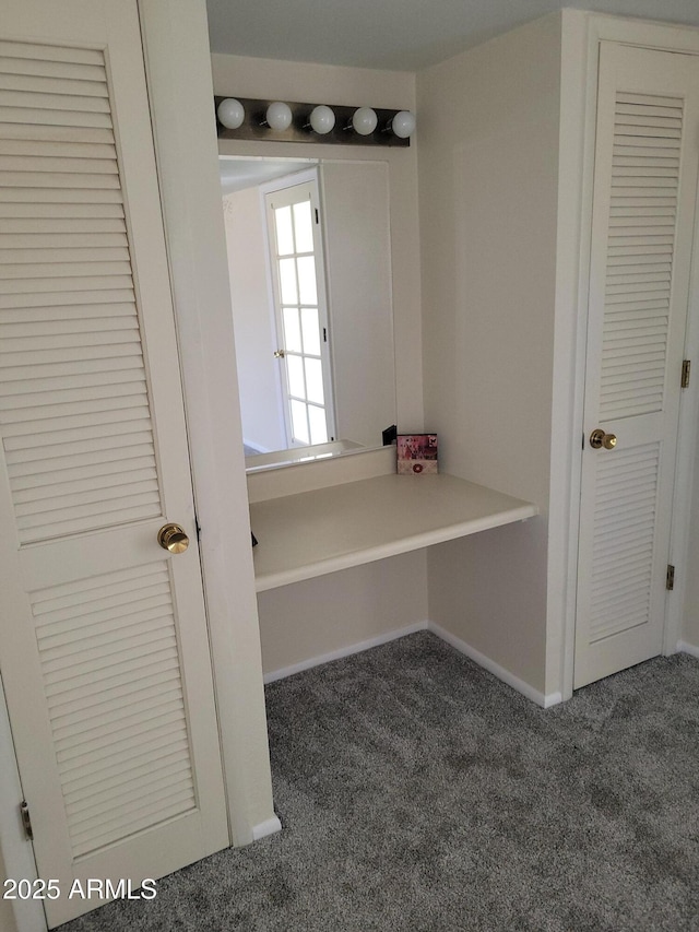 interior space featuring dark colored carpet