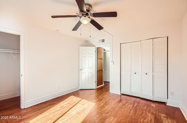 unfurnished bedroom with ceiling fan and hardwood / wood-style flooring